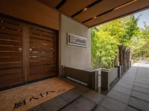 a front door of a house with a sign that reads garma at Kuriya Yasohachi in Kaga