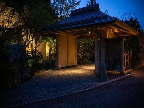 a gazebo with a roof at night at Kuriya Yasohachi in Kaga