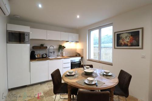 a kitchen and dining room with a table and chairs at Les Gites de Mael et Rose in Plougasnou