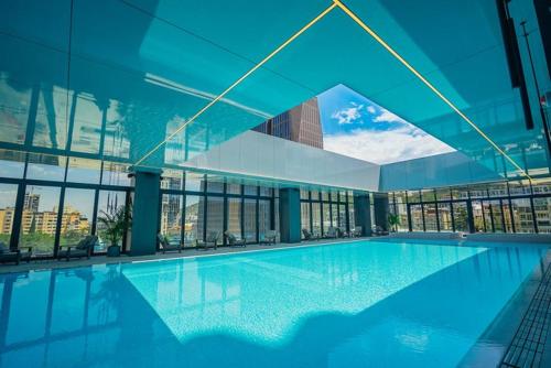 a large swimming pool in a large building at Downtown Residence in Tbilisi City