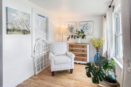 a living room with a chair and a dresser at Beachside in Branford in Stamford