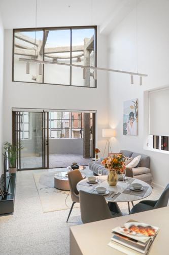 a living room with a couch and a table at Stanley Lane Residence Darlinghurst in Sydney