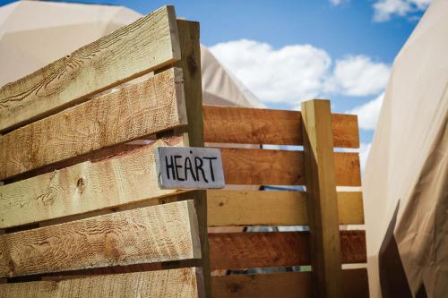 a wooden fence with a heart sign on it at Pure Heart Retreat in Cody