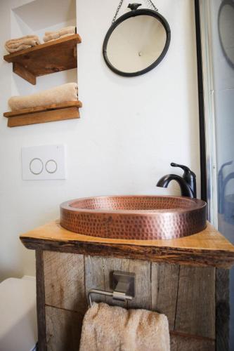 a bathroom with a copper sink on a wooden counter at Pure Heart Retreat in Cody