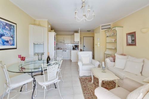 un salon avec un canapé et une table dans l'établissement T3 in Mandelieu with Terrace AC Parking Swimming Pool Tennis - BENAKEY, à Mandelieu-la-Napoule