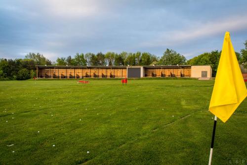 a yellow flag in a field with a building at Mercure Newcastle George Washington Hotel Golf & Spa in Newcastle upon Tyne
