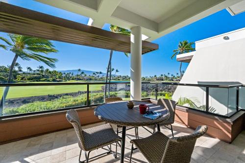 a patio with a table and chairs on a balcony at Mauna Lani Point in Waikoloa
