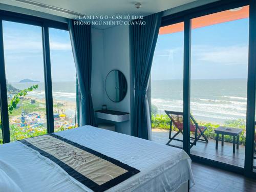 a bedroom with a bed and a view of the ocean at Flamingo Hải Tiến - Căn góc 2 Phòng - View 2 mặt biển in Thanh Hóa