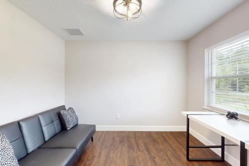 a living room with a couch and a window at Royal Highlands Retreat in Weeki Wachee