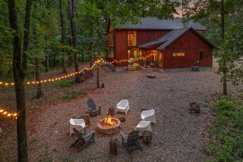a fire pit in front of a cabin with lights at Meadows Edge Cabin in Broken Bow