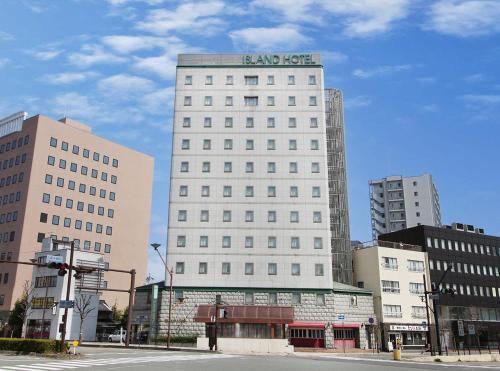 a white building with a sign on top of it at Island Hotel in Nagano