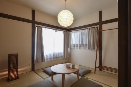 a living room with a table and a large window at 森下別邸 in Tokyo
