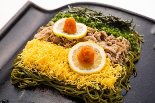 a plate of food with spaghetti and meat and squash at Hotel Sumire ふぐ料理を愉しむ料理宿 in Shimonoseki