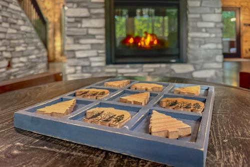 a tray of crackers on a table with a fireplace at Meadows Edge Cabin in Broken Bow