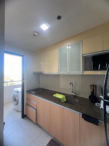 a kitchen with a sink and a counter top at The mactan newtown 1 Bedroom , Beach is P 350 pp in Punta Engaño