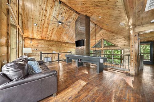 a living room with a couch and a ping pong table at Meadows Edge Cabin in Broken Bow
