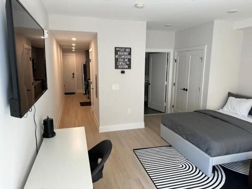 a bedroom with a bed and a flat screen tv at Luxury Stay for NYC visit Jersey City 7 Min Walk NYC Train Station in Jersey City
