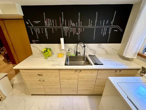 a kitchen with a sink and a counter top at Cozy PDX Hideout, Ideal Location in Portland