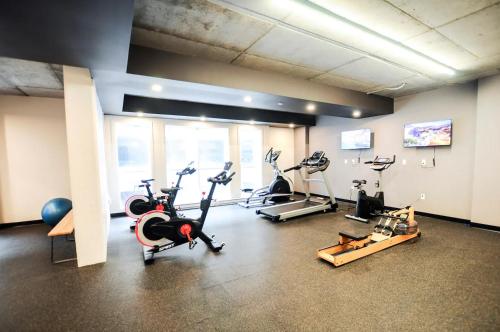 a gym with several treadmills and exercise bikes at Rustic, Downtown Quebec, Rooftop pool, 2 bedrooms AND 2 bathrooms -up to 6 guests in Quebec City
