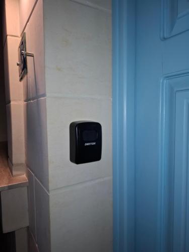 a paper towel dispenser on a wall next to a door at Sea & Sky townhouses in Marsaxlokk