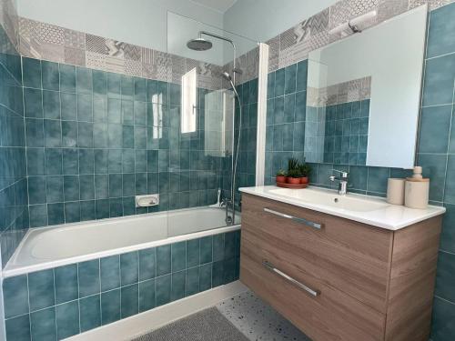une salle de bain avec une baignoire et un lavabo et une baignoire tubermottermott dans l'établissement Appartement T2 lumineux avec balcon, parking et proche centre-ville – 4 pers - FR-1-392-240, au Pouliguen
