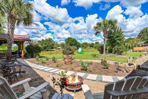 a patio with chairs and a fire pit and a park at Bella Fiori in Buda