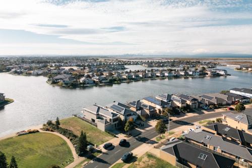 an aerial view of a town next to a river at Luxury Waterfront Villa in Sanctuary Lakes in Point Cook