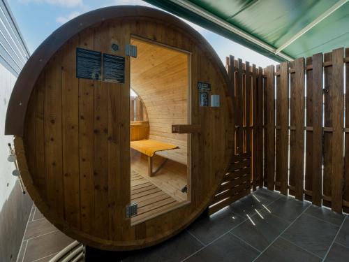 a wooden sauna with a bench in the middle at Rakuten STAY HOUSE Amakusa in Yanagi