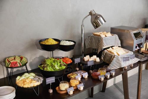 a buffet with various food items on a table at Livable Hotel Bangkok in Bangkok