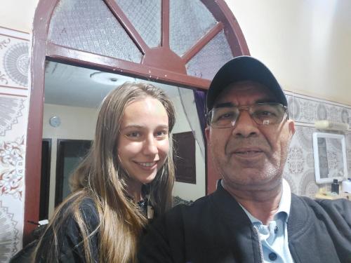 a man and a woman standing in front of a mirror at Airport Agadir Guest House in Agadir