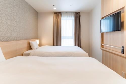 Una cama o camas en una habitación de Kansai International Airport Hotel 11