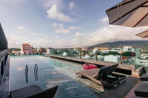 a swimming pool on the roof of a building at Art Mai Gallery Nimman Hotel Chiang Mai - SHA Plus in Chiang Mai