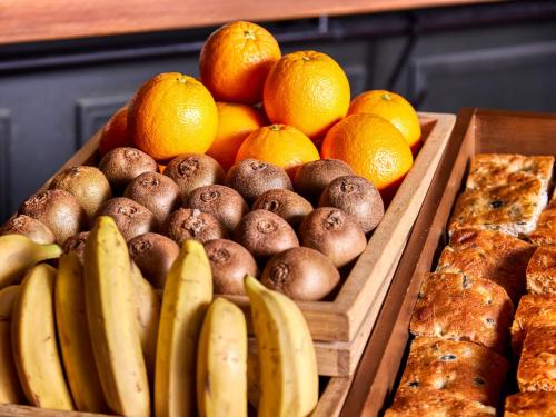 a display of fruits and vegetables and bread and oranges at the square hotel GINZA in Tokyo