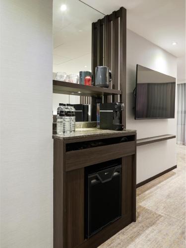 a kitchen with a counter with a coffee maker at The Tango Hotel Taipei Linsen in Taipei