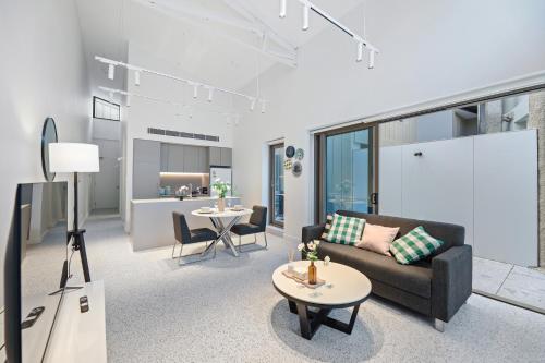 a living room with a couch and a table at Stanley Lane Residence Darlinghurst in Sydney