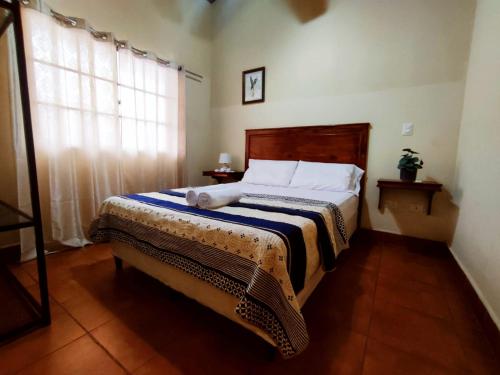 a bedroom with a bed and a window at Hotel Casona Macondo, Granada, Nicaragua in Granada