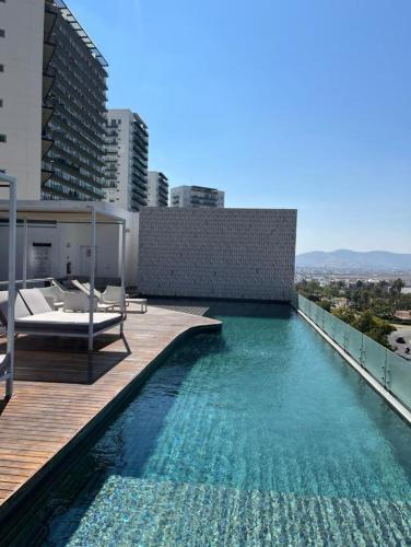 a swimming pool on the roof of a building at Hotel Sonata Angelopolis in Lomas de Angelopolis