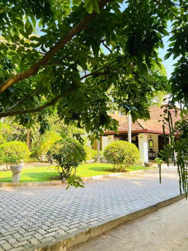 a cobblestone street in front of a house at Krishan Villa in Negombo