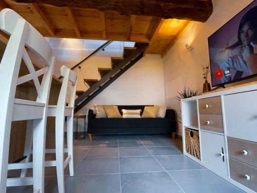 a living room with a couch and a staircase at Casa do Tronco in Bragança