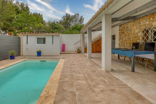 une maison avec une piscine et une table dans l'établissement Location avec piscine & parking privé à Bandol, à Bandol