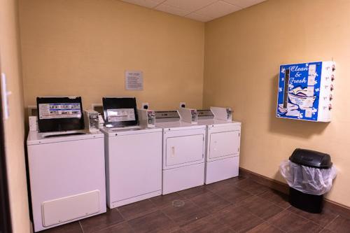 a row of washing machines in a room at Rivers Inn and Suites in Three Rivers