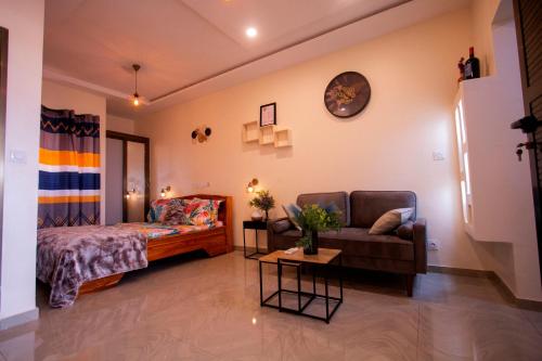 a living room with a bed and a couch at APPART Studio in Lomé