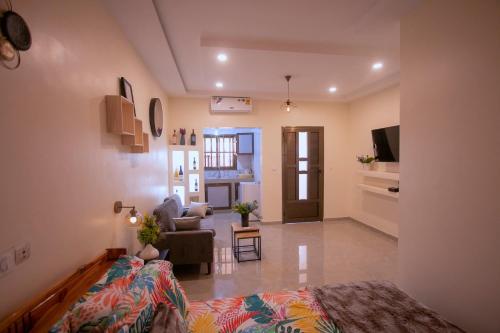 a living room with a bed and a couch in a room at APPART Studio in Lomé