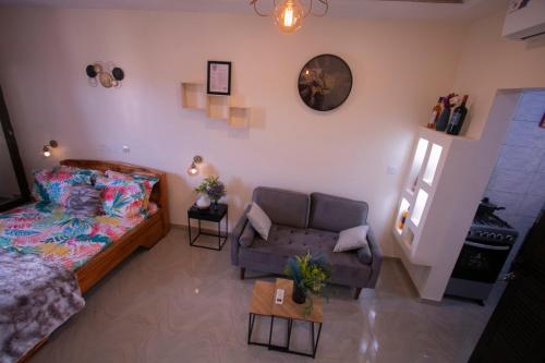a living room with a couch and a chair at APPART Studio in Lomé