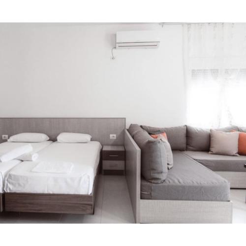 a living room with a bed and a couch at Villa Melodia Xhek in Ksamil