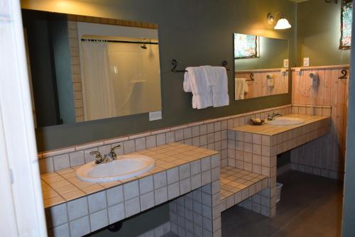 a bathroom with two sinks and a mirror at Retreat Wilderness Inn in Nimpo Lake