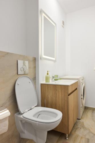 a bathroom with a white toilet and a sink at 20 Apartment Centre in Bucharest
