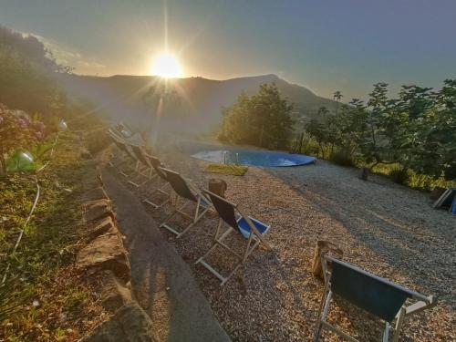 a group of chairs sitting on a hill with the sunset at Dimora dei Cardinali in Agropoli