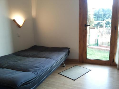a bedroom with a bed and a door to a yard at Holiday Home El Romani in Calafell