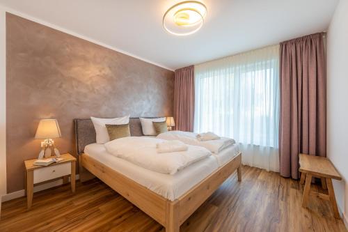 a bedroom with a large bed and a window at Ferienwohnung Blickwinkel in Lohme